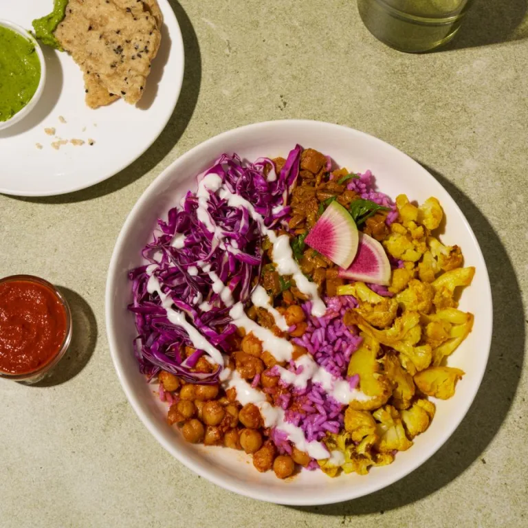 Heart + Soul shawarma bowl with roasted cauliflower, chickpeas, cabbage slaw, radishes, and creamy dressing.