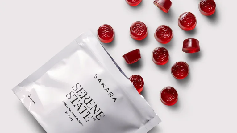 Sakara Serene State pouch displayed on a light background surrounded by red Serene State gummy supplements.