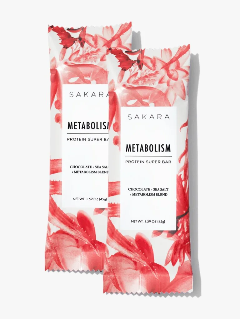 Two Sakara Metabolism Protein Super Bars chocolate sea salt flavor in white and red floral wrapper, 1.59 oz, featuring metabolism blend.