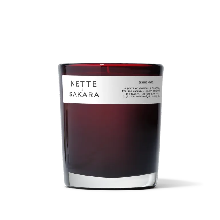 Sakara x Nette Serene State Scented Candle in deep red translucent glass vessel with white label reading Serene State.