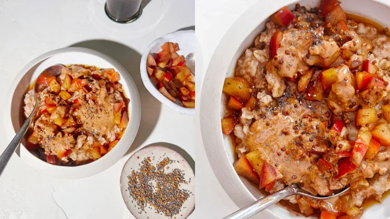 Bowl of oatmeal topped with diced apples and seeds, with a smaller bowl and spoon beside it.