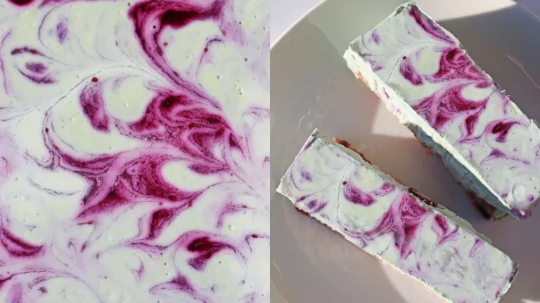 Close-up of purple-and-white marbled cheesecake bars on a light surface.