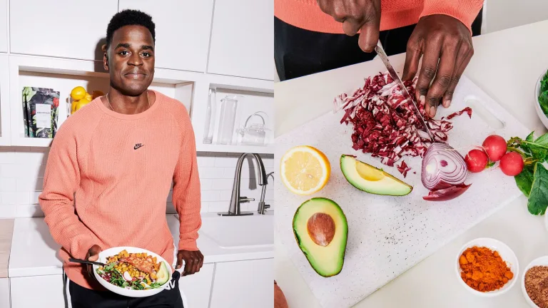 in a kitchen holding a bowl of food beside chopped vegetables including avocado, lemon, and radishes.