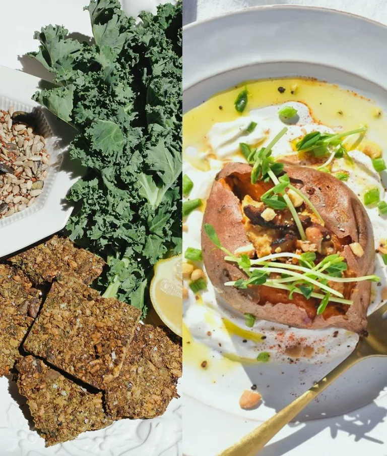 Plate with seeded crackers, kale leaves, lemon wedges, and a bowl of grains beside a plated stuffed sweet potato.